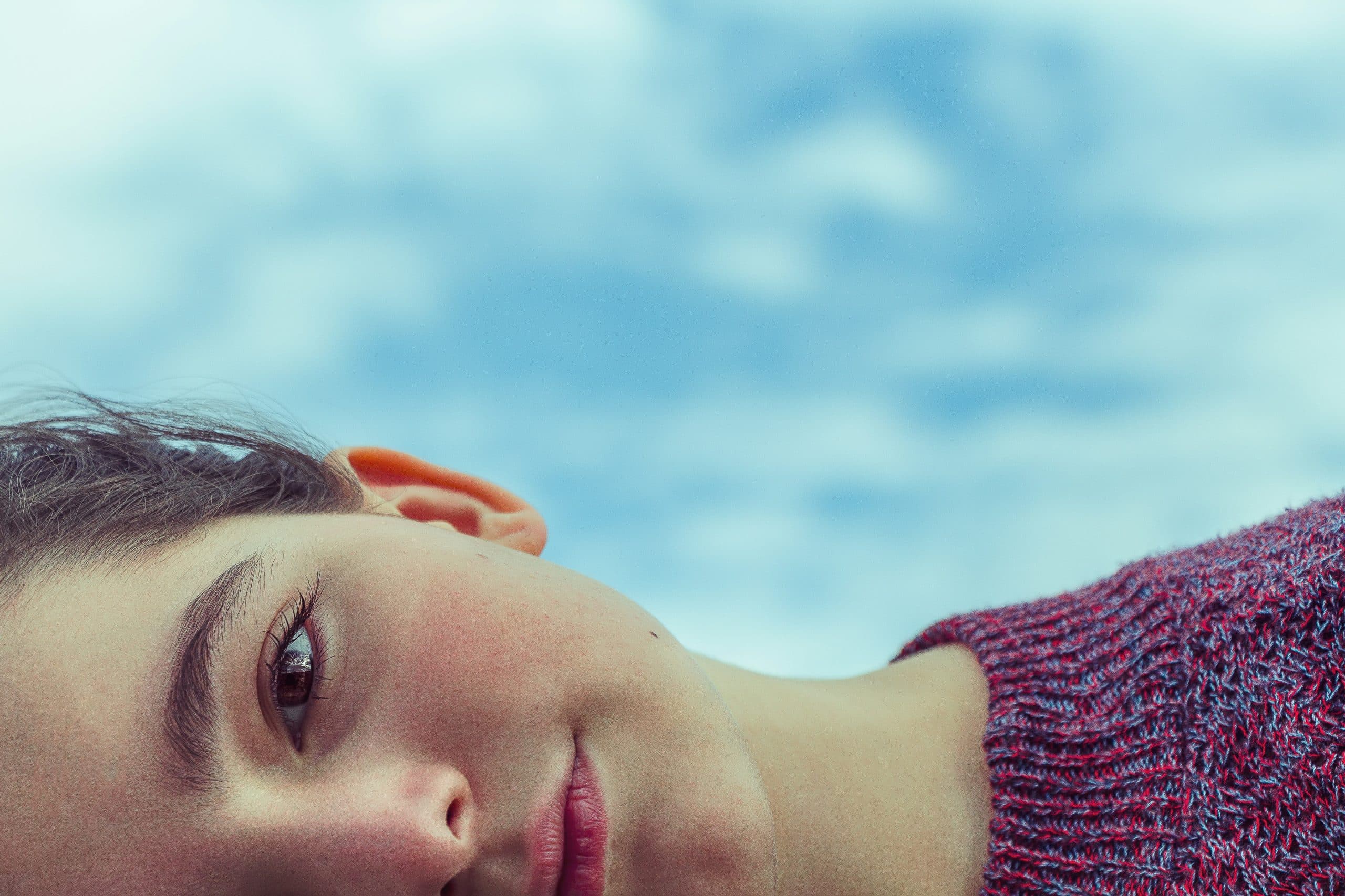 women lying sideways looking directly at the camera